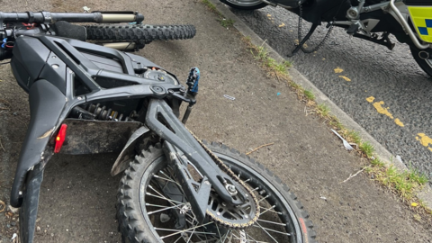 An electric bike on its side on the ground