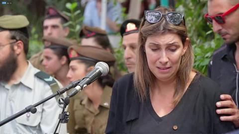 During a soldier's funeral in Israel, a crowd of hundreds were forced to take cover as sirens went off.