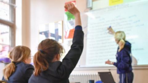 File photo dated 12/09/18 of a teacher and students in a classroom. Only one in 10 state schools say all their pupils are studying a language at GCSE level, compared with nearly a third of private schools, a report suggests.