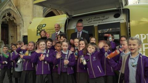 A group of kids with Michael Gove