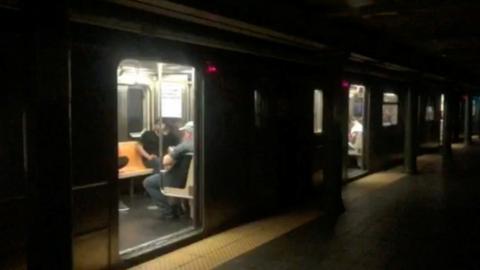 Train at darkened platform at 66th Street subway station in Manhattan, NY, 13 July 2019