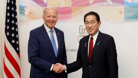 U.S. President Joe Biden and Fumio Kishida, Japan's prime minister, shake hands prior to a bilateral meeting ahead of the Group of Seven (G-7) leaders summit in Hiroshima, Japan
