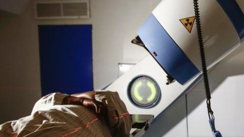 A patient lies on their back in a radiotherapy machine in Khartoum.