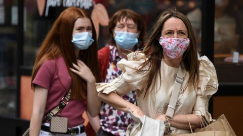 Shoppers wearing protective face coverings in London on 5 July 2021