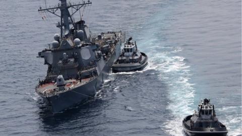 guided missile destroyer USS Fitzgerald next to tugboats off the Shimoda coast after it collided with a Philippine-flagged container ship on June 17, 2017.