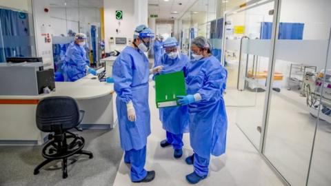 Health workers wearing full PPE at Whiston Hospital in Merseyside