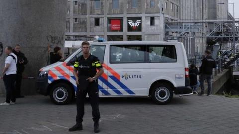 A policeman stands by as police evacuate the concert venue Maassilo on 23 August