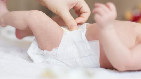 Woman changing nappy of a baby