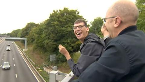 Alex Chesters waving on the bridge