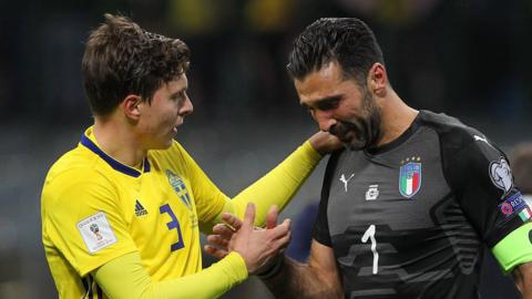 Victor Lindelof, Sweden, comforts Gianluigi Buffon, Italy