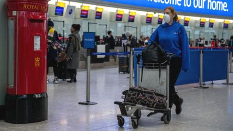 Woman in airport wearing face mask