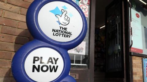 The National Lottery sign outside a shop