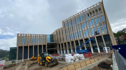 The new building being built on the riverside