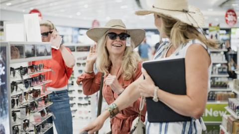 Women buying sunglasses