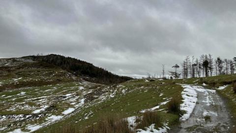 Melting snow over hills in Wales