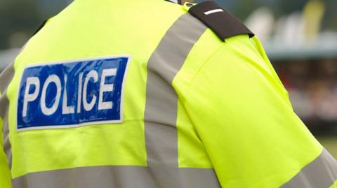 A policeman in a high visibility jacket