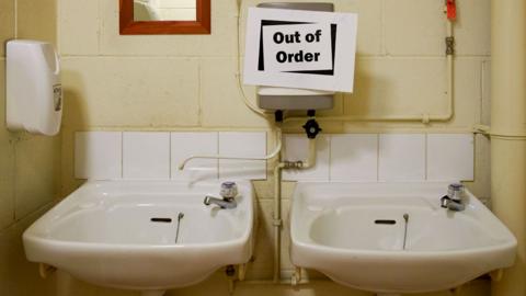 Out of order signs on toilet sinks. [SINGLE USE ONLY PIC]