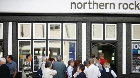 Customers queue outside a Northern Rock branch in 2007
