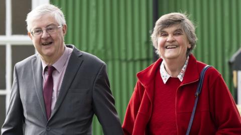 First Minister of Wales Mark Drakeford leaves the Kings Road polling station in Pontcanna with his wife Clare after voting on May 5, 2022 in Cardiff, Wales.