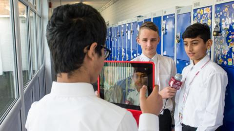 Students record video with a tablet