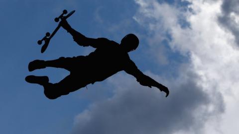 A skateboarder catches some air