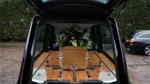 A coffin inside a hearse
