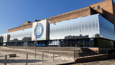 Brutalist nineteen eighties school building, mainly concrete with glass frontage