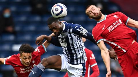 West Brom and Liverpool players contest a header