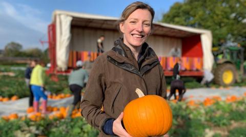 Farmer Hazel with a pumpkin