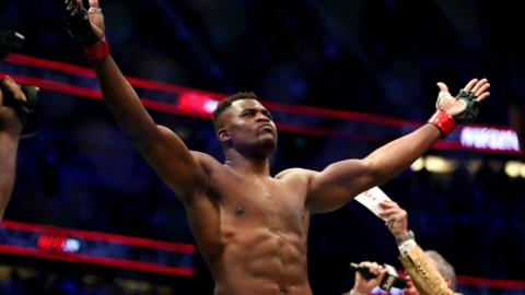 Francis Ngannou holds his arms out as he is announced