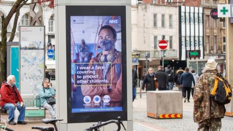 A government health warning is displayed on a sign in Sheffield