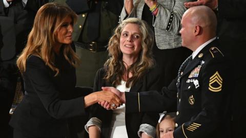 First Lady Melania Trump (L) greets Sgt Townsend Williams (R) alongside his daughter and his wife Amy (C) after returning from deployment in Afghanistan (4 Feb)