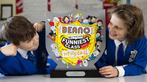 Students Anthony Floarea (left) and Gavriil Stovl from Northside Primary School pull faces as they hold the Beano trophy