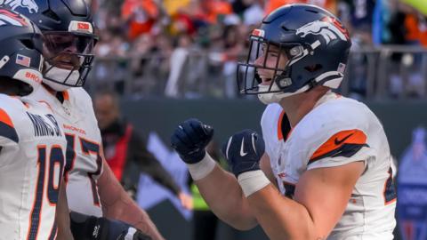 Nate Adkins celebrates a touchdown for the Denver Broncos against the New York Jets