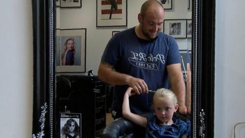 Father styling daughter's hair