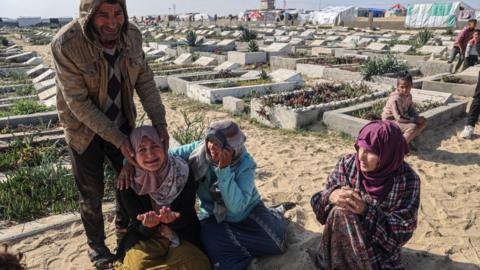 Relatives mourn during the funeral of loved ones killed during overnight Israeli strikes in the Gaza Strip