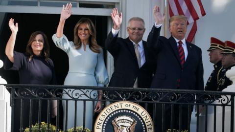 President Donald Trump and first lady Melania Trump, Australian Prime Minister Scott Morrison and his wife Jennifer Morrison wave from the White House on 20 September