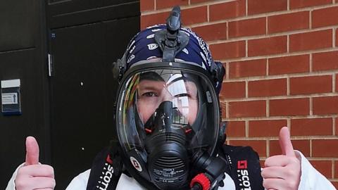 Dr Karen Perkins in breathing apparatus being used during tests for the ambulance cleaning procedure