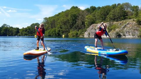 Children on paddleboards at Wick quarry
