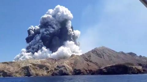 Smoke from the volcanic eruption of Whakaari, also known as White Island, is pictured from a boat on 9 December, 2019