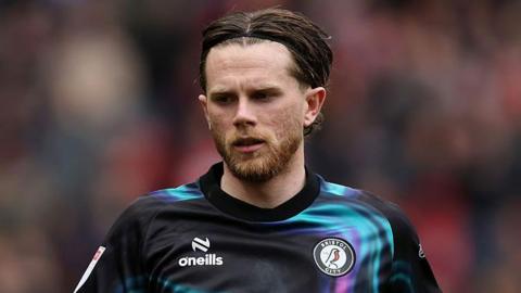 Max Bird in a black and turquoise patterned Bristol City jersey during a match.