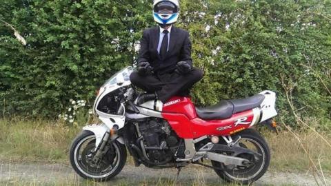 Steven McDermott standing with motorbike