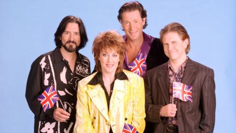 Katrina and the Waves, pictured in 1997, holding small Union Jack flags