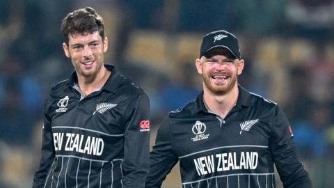 New Zealand's Mitchell Santner (left) and Glenn Phillips celebrate taking a wicket v Afghanistan