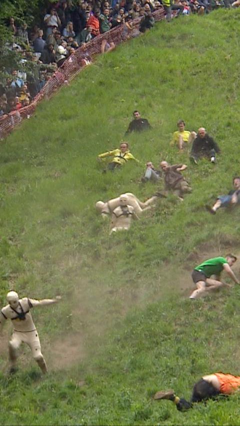 Competitors running down Cooper's Hill at the annual cheese roll.
