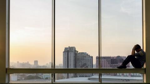 Man sitting in window