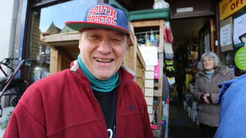 Derek Knapman in front of his shop