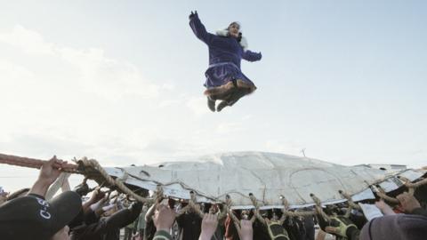 At Nalukataq, the summer whaling festival, the village comes out to celebrate a successful whaling season and to give thanks to the whale for its gift. Here, successful crewmembers do the blanket toss They are thrown up to thirty feet in the air, and depend on everyone's hands to land safely.