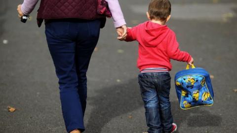 Woman and child walking to nursery