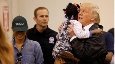 President Donald Trump and First Lady Melania Trump greet children at a centre for flood survivors of Hurricane Harvey, in Houston, Texas,